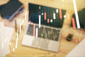 Image of trading price charts overlaid on an image of a laptop, meant to illustrate index mechanics